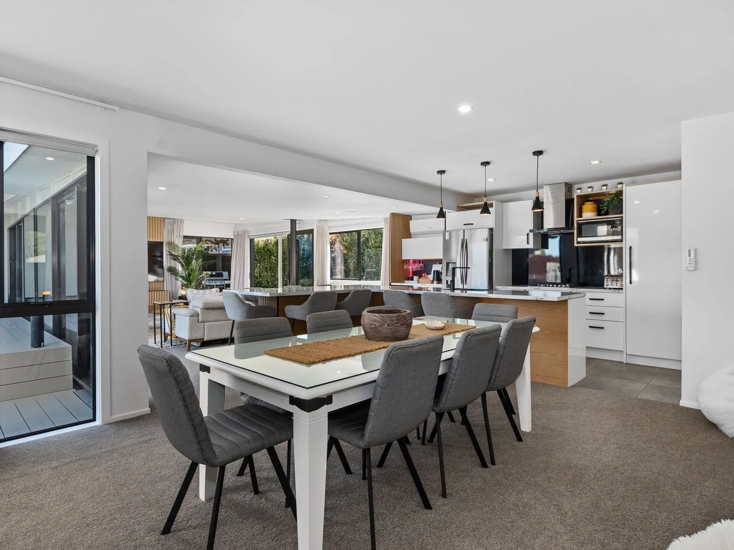 Una zona de comedor y cocina en Sun Kissed Pool Villa - Casa de vacaciones en Mangawhai, Mangawhai Heads