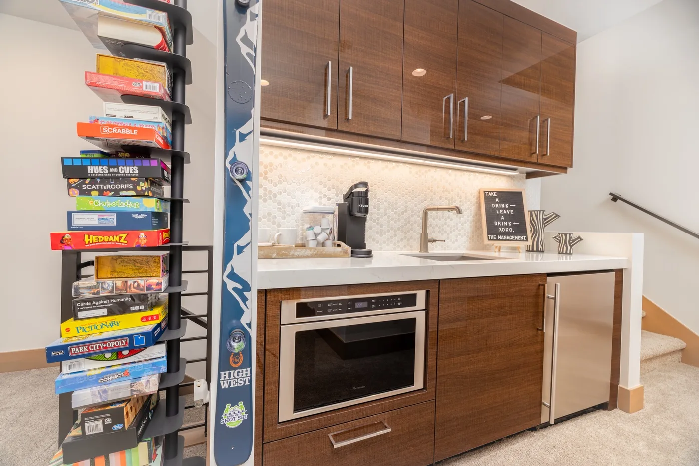 A compact kitchen with wood cabinets, a countertop, and a built-in oven.