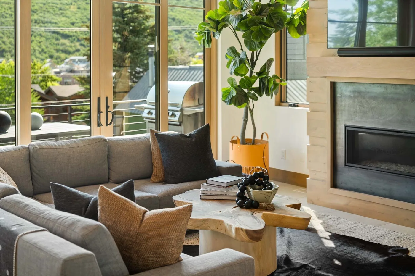 A living room with a sectional seating area and a wood coffee table.