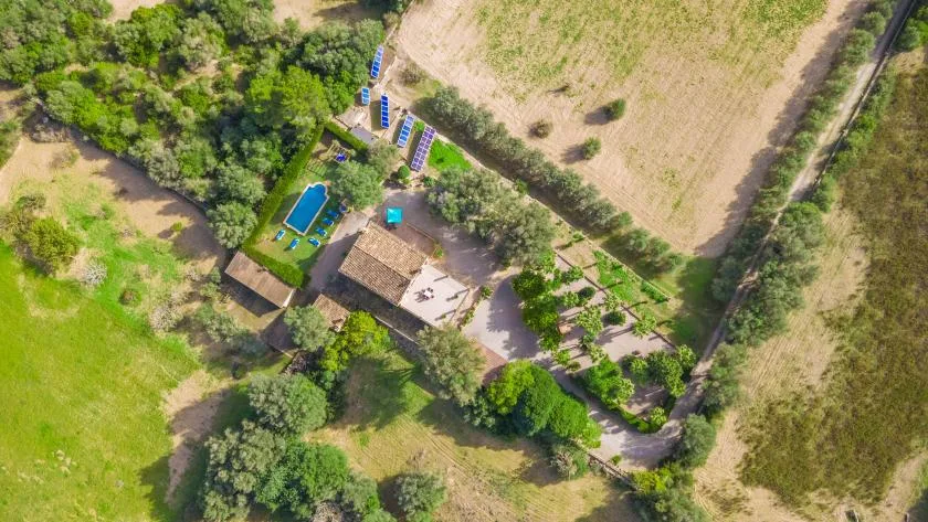 Vista aérea de una propiedad rural con piscina y vegetación alrededor.
