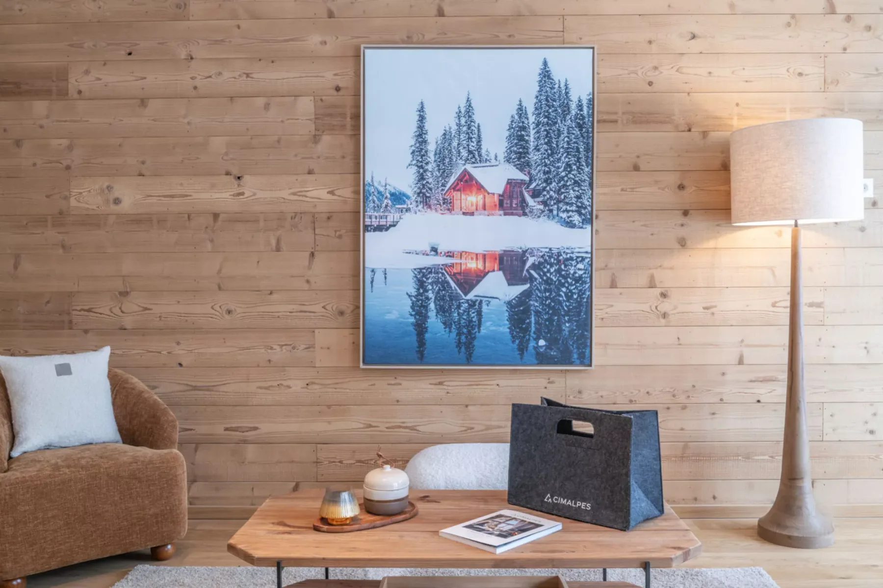 A wood-paneled living room with seating, a coffee table, and framed wall art.