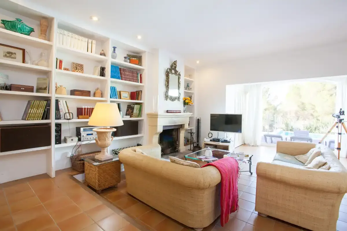 A bright living room with built-in bookshelves and seating.