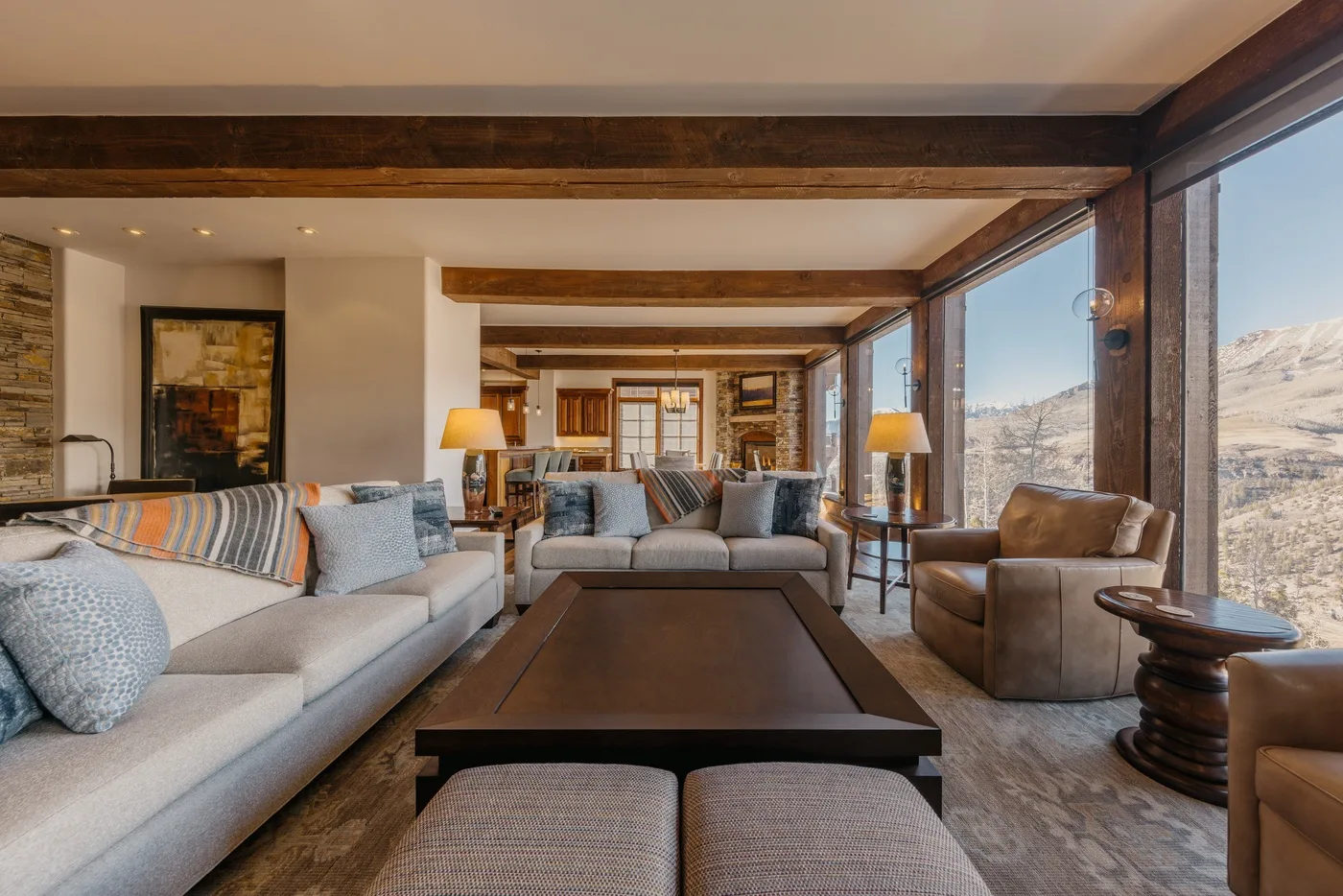 A spacious living room with seating arranged around a low coffee table.