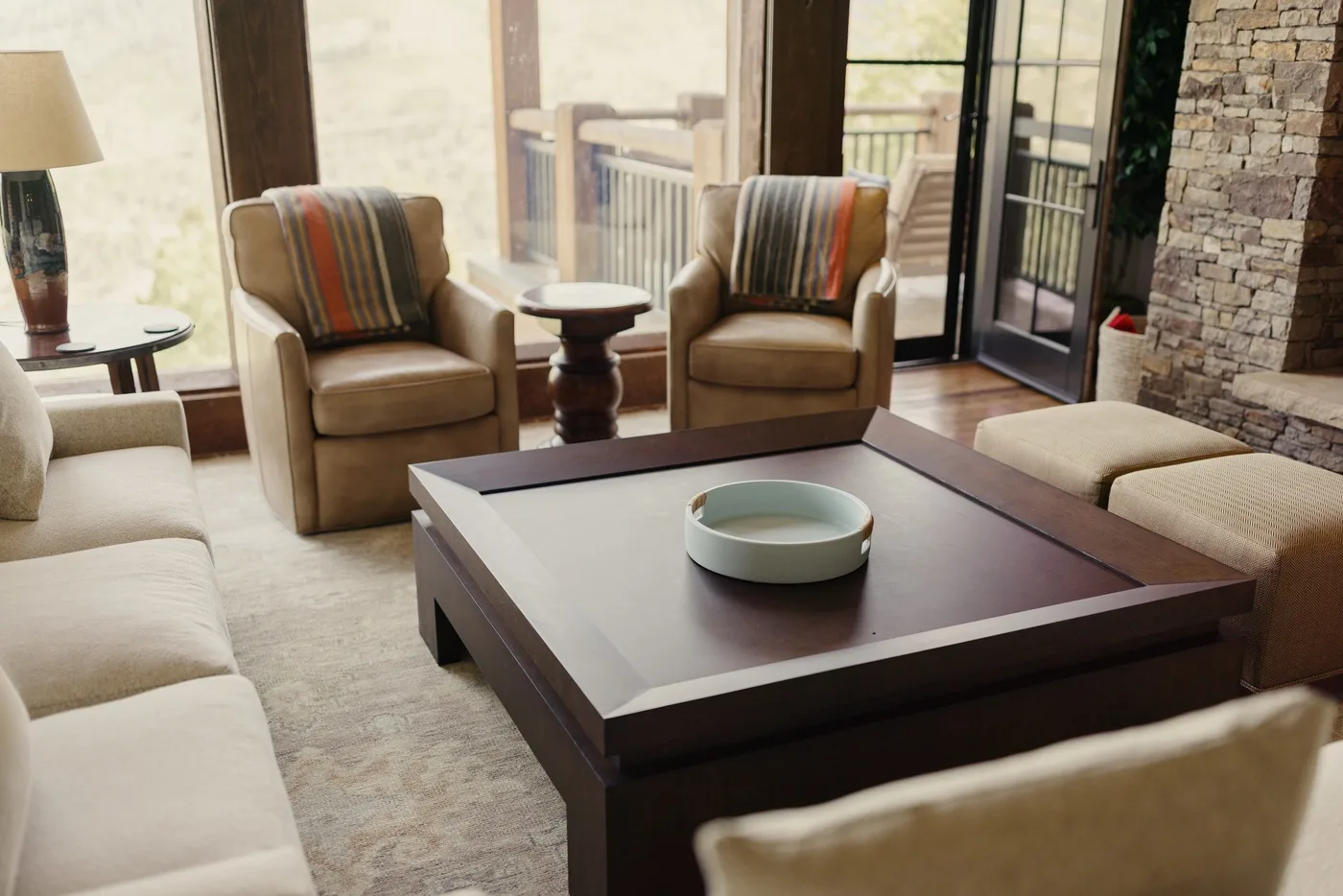 A living room seating area with armchairs arranged around a low coffee table.