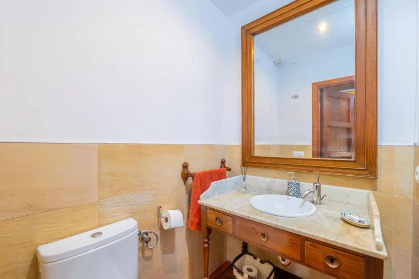 A bathroom vanity with a sink, mirror, and tiled walls.
