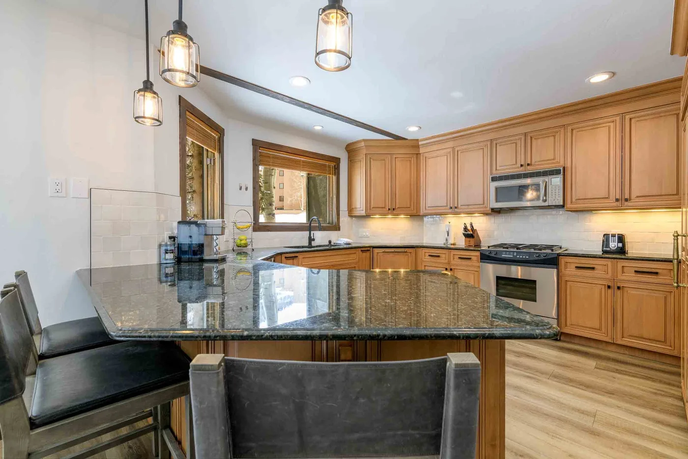 A kitchen with wooden cabinets and a large central island.