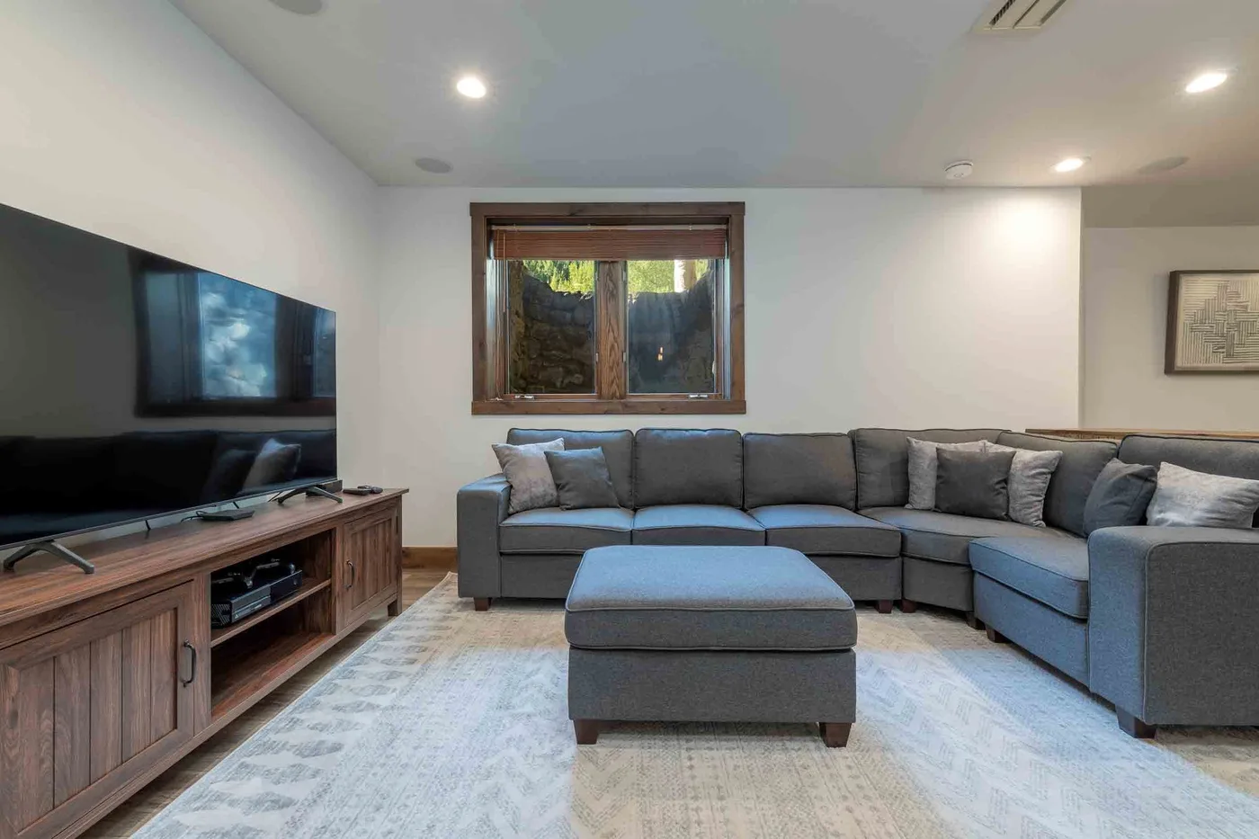 A living room with sectional seating and a television.