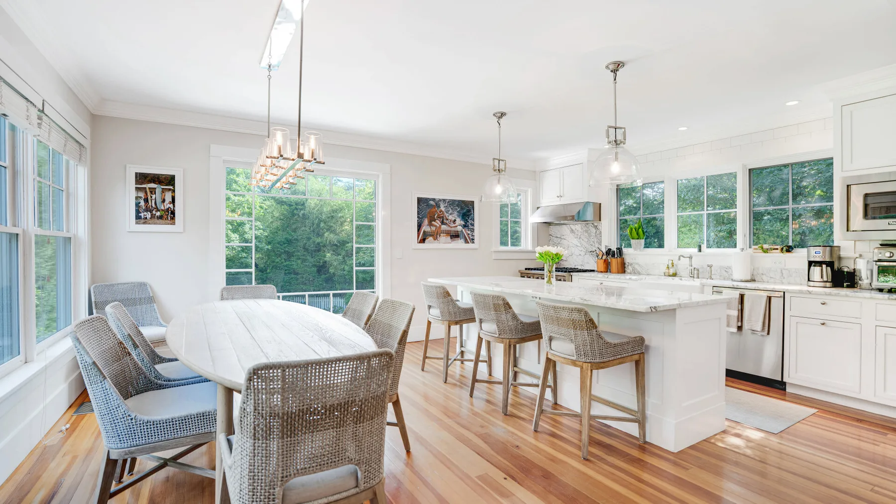 A bright kitchen and dining area with a large island and dining table.