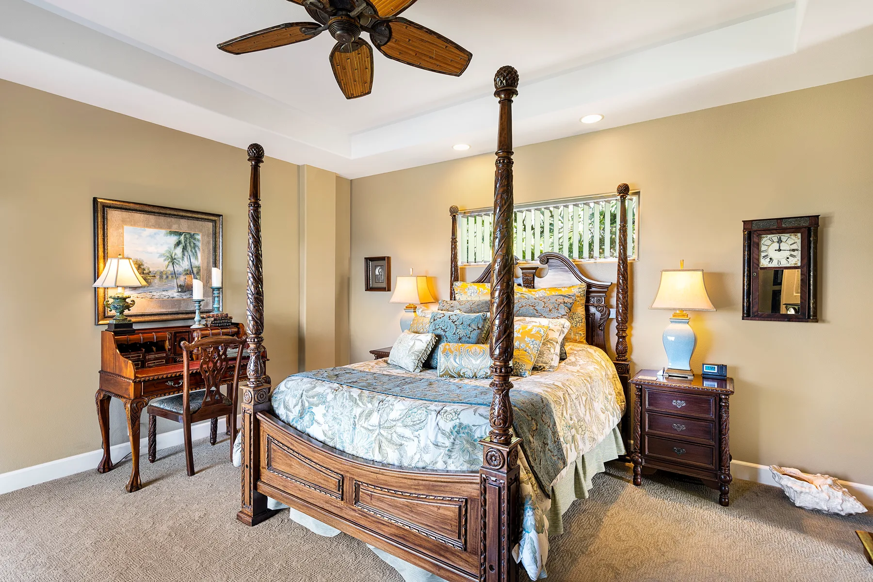 A bedroom with a wooden four-poster bed and matching bedside tables.
