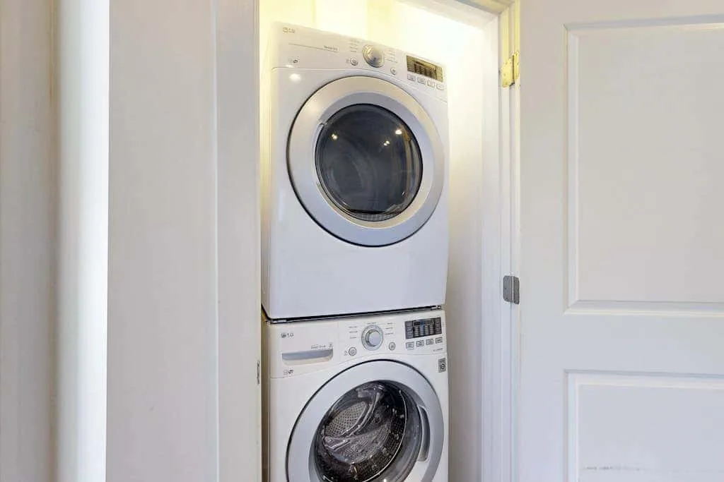 A laundry closet with a stacked washer and dryer.