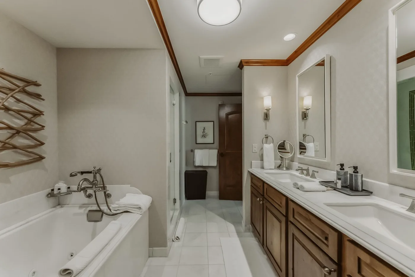 A bathroom with a bathtub and a long vanity with sinks.
