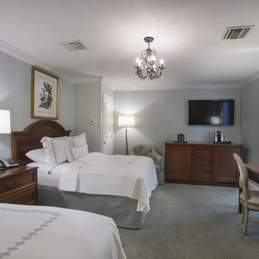 Standard Double/Double room with two beds and a chandelier.