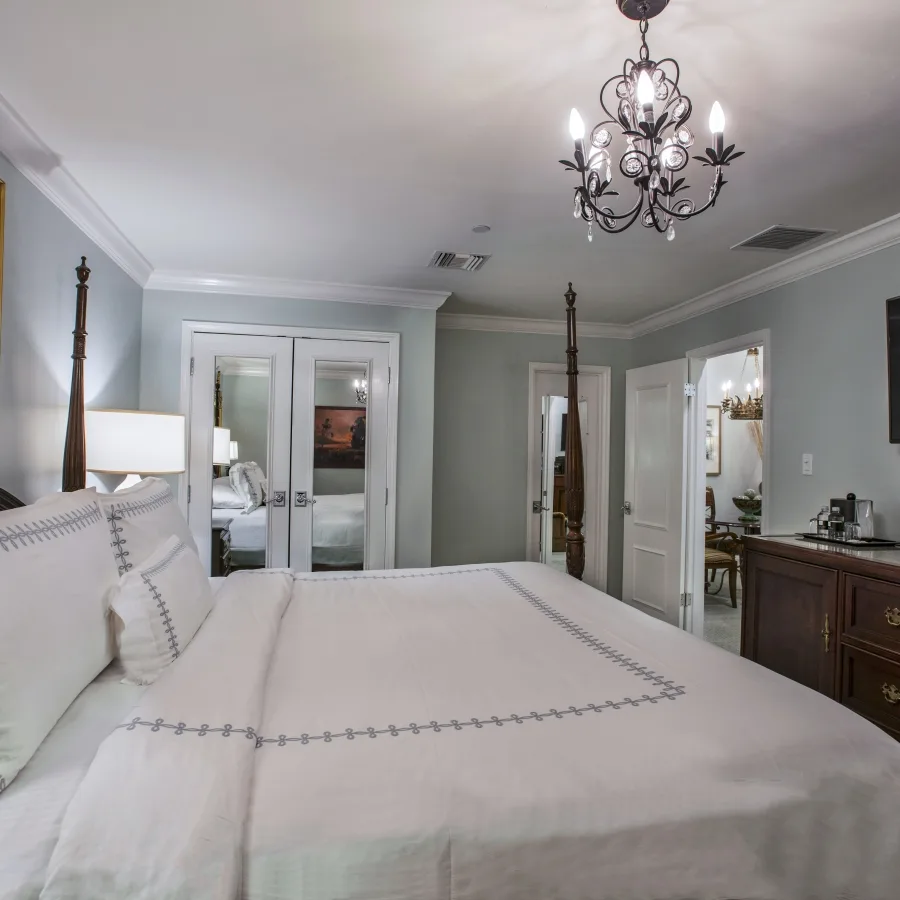 Interior Suite bedroom with a king bed, nightstands and mirrored closet.
