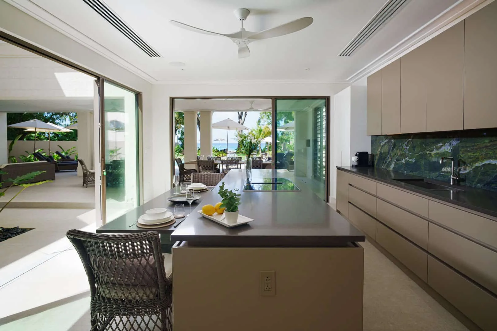 A bright open kitchen with a long island and sliding glass doors to a patio.