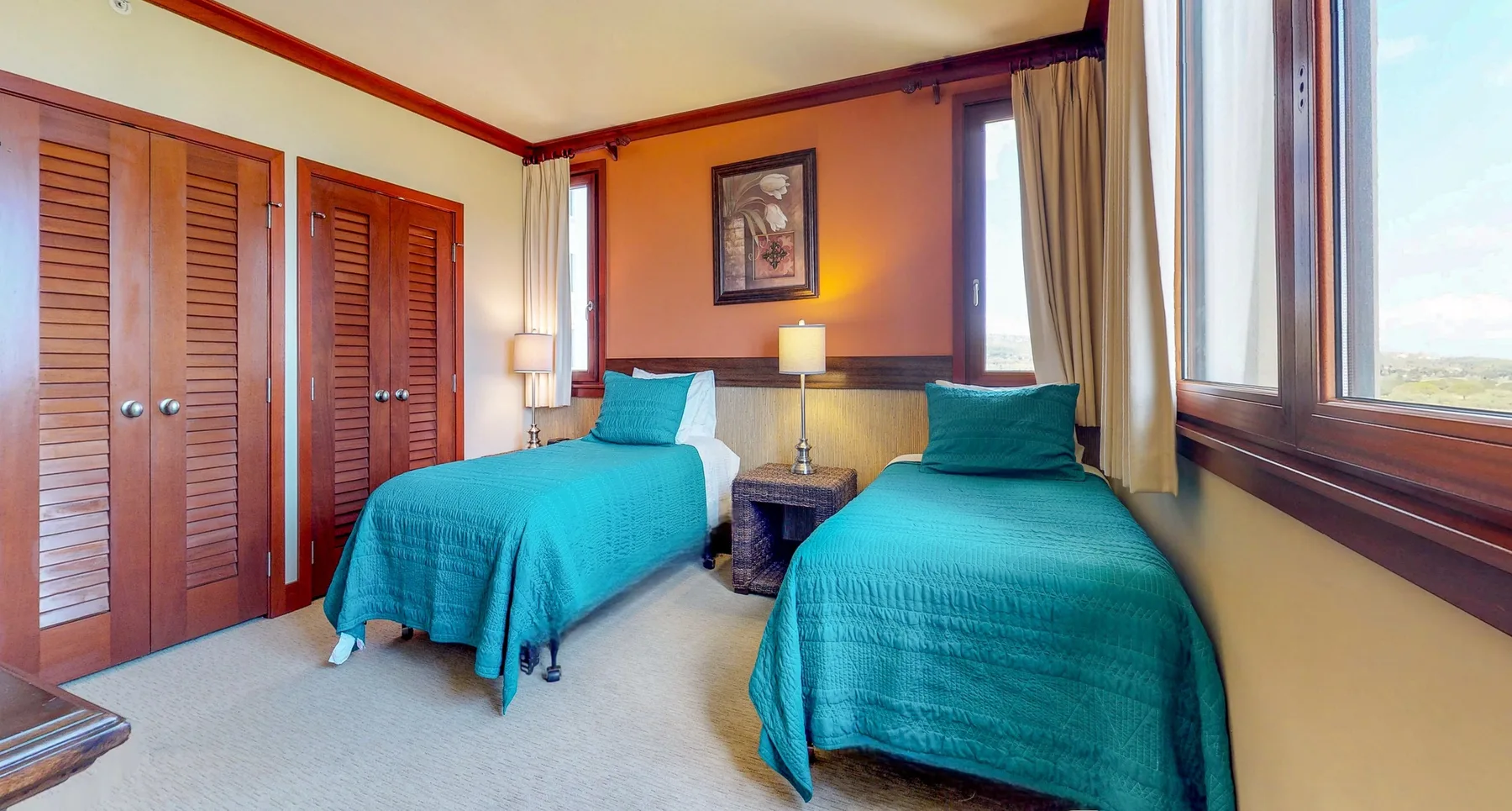 A bedroom with two beds and wooden closet doors.