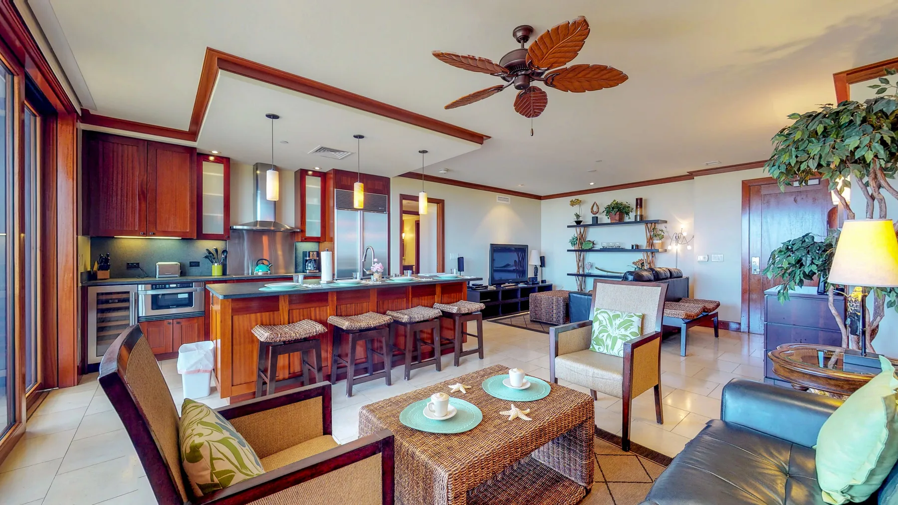 An open-plan living room and kitchen with a dining island and seating.