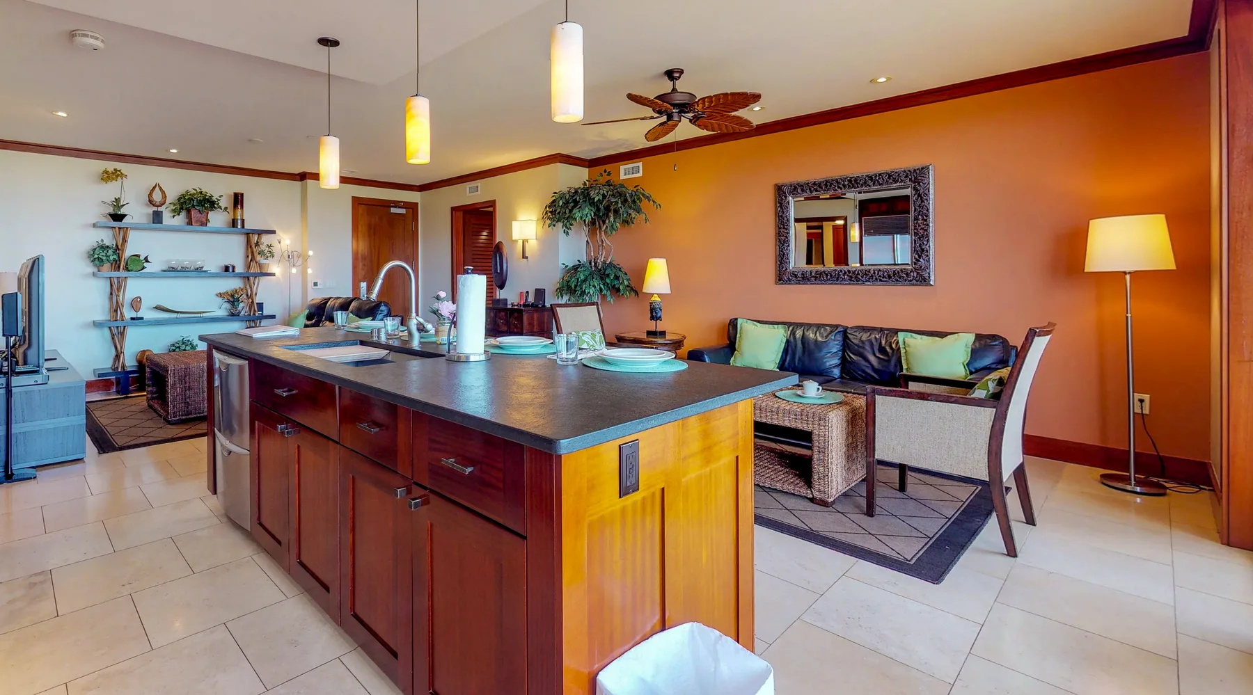 A colorful open-plan living area with a kitchen island and seating.