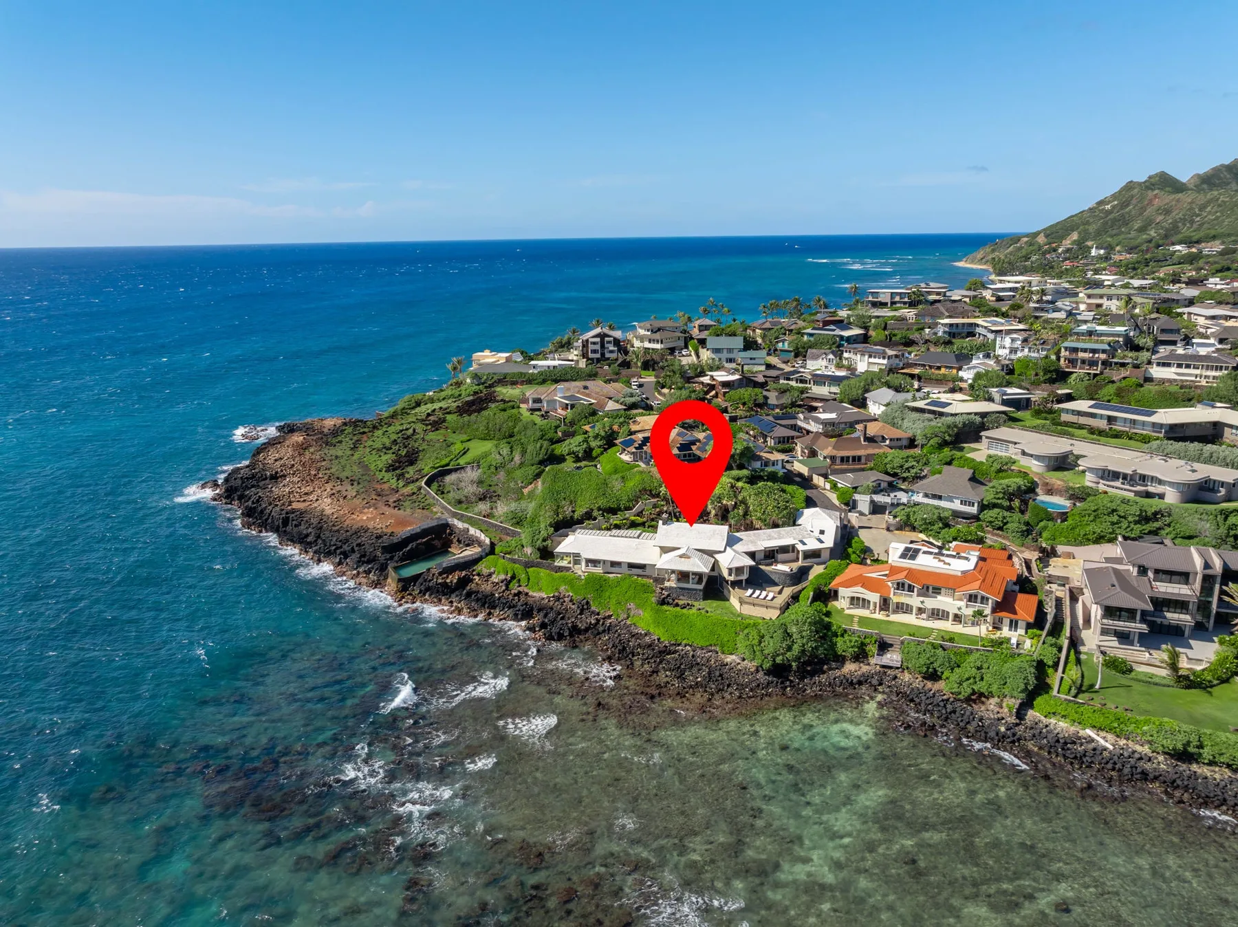 Aerial view of a coastal neighborhood beside the ocean.