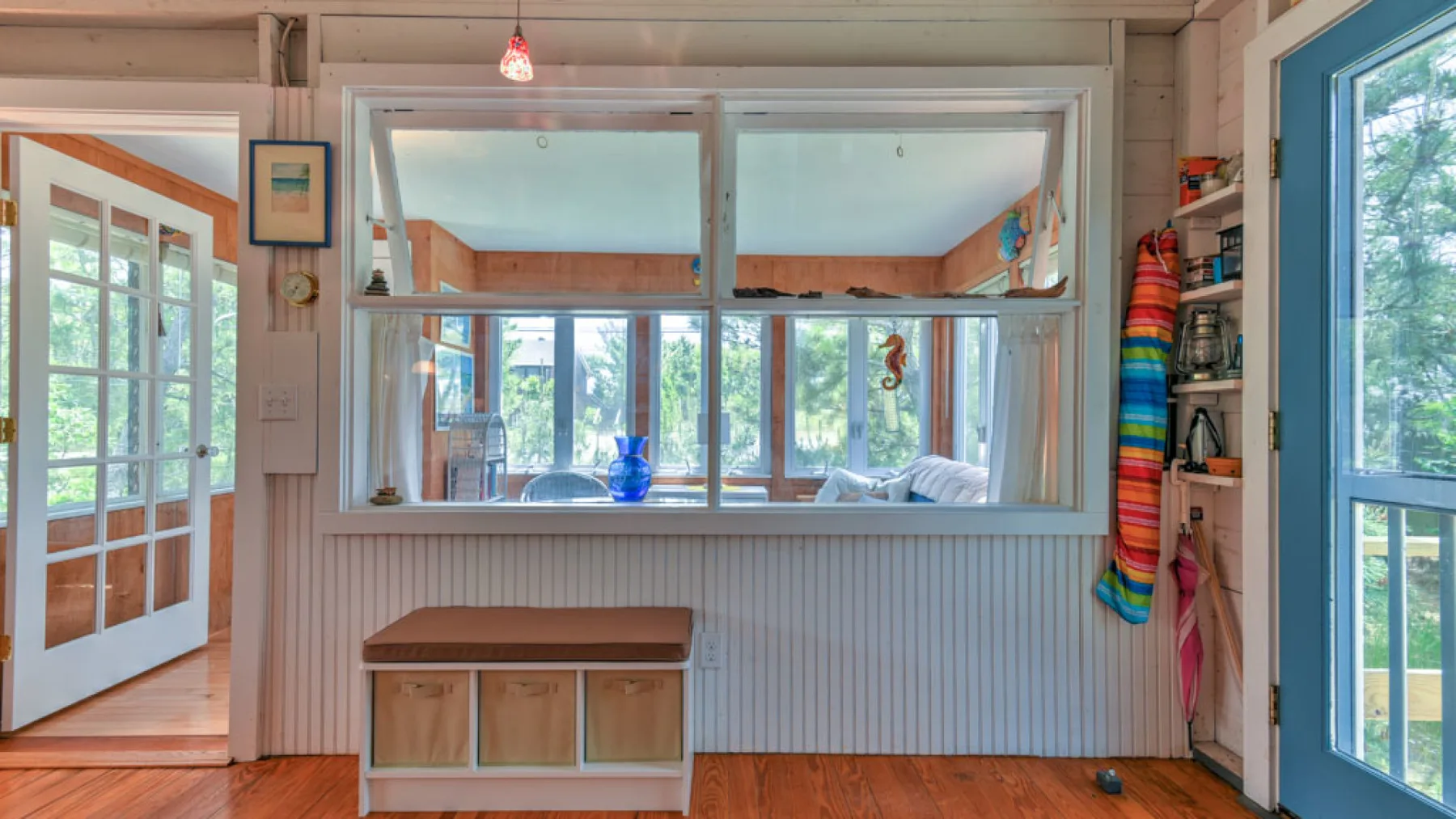 A bright sunroom with large windows and a built-in bench.