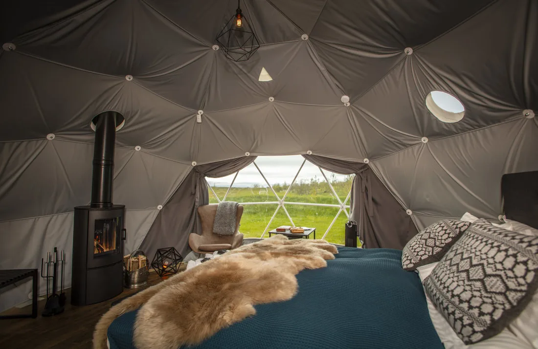 Standard Dome bed with sheepskin and fireplace