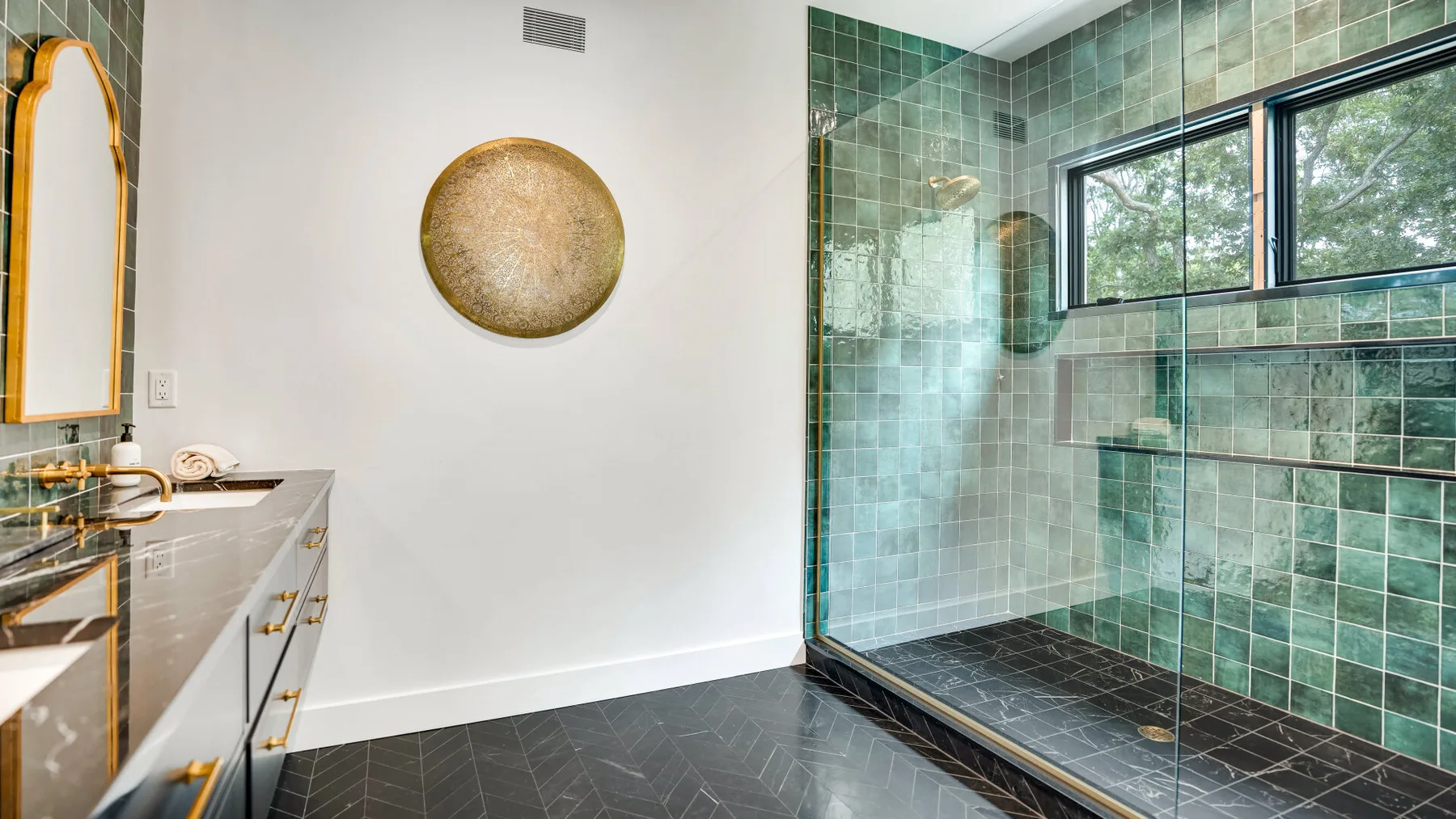 Un baño moderno con una ducha de vidrio y un tocador.
