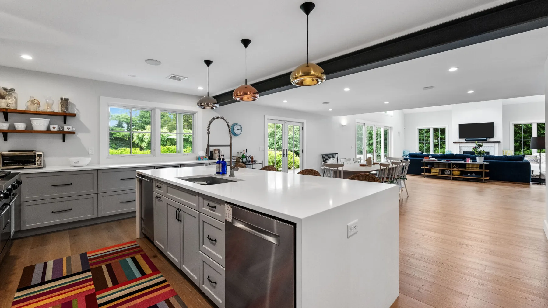 An open-plan kitchen and living area with a large island and dining table.