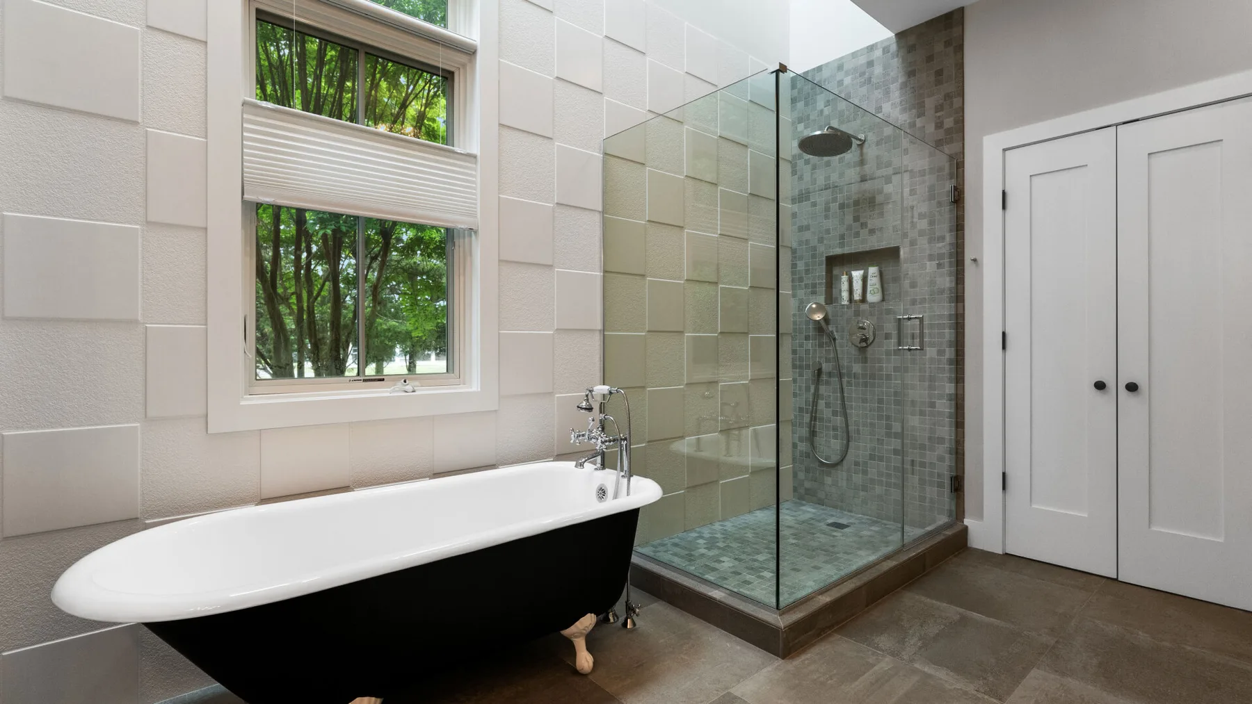A bathroom with a freestanding bathtub beside a glass shower.