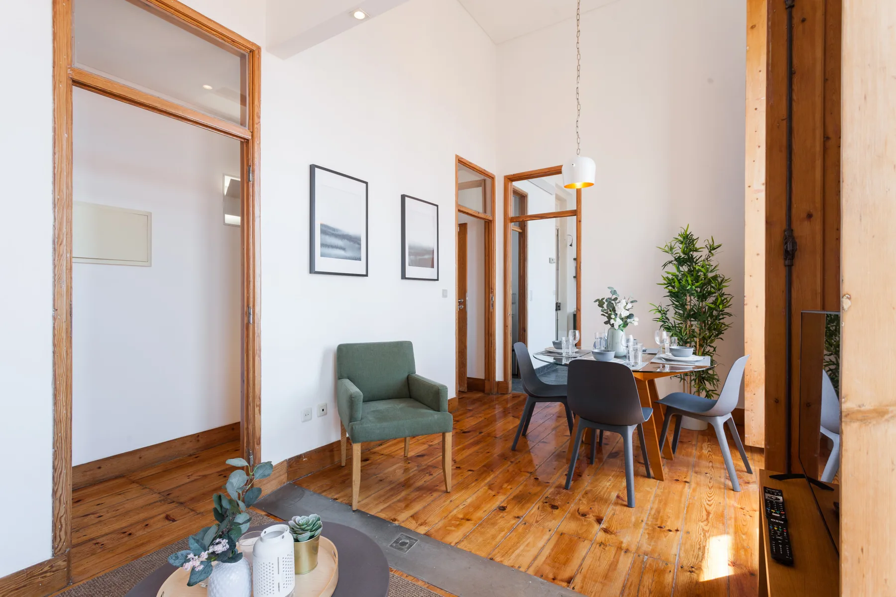 A dining and sitting area with a table, chairs, and an armchair.