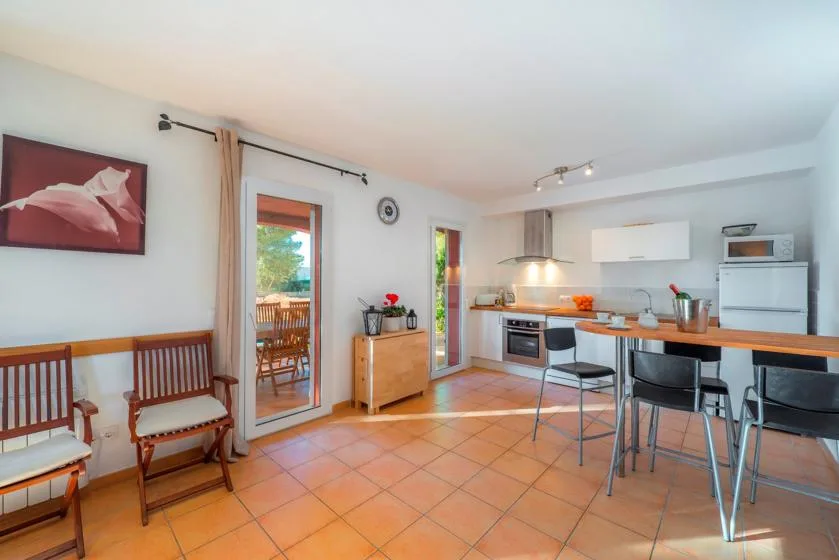 A bright kitchen and dining area with a counter and seating.