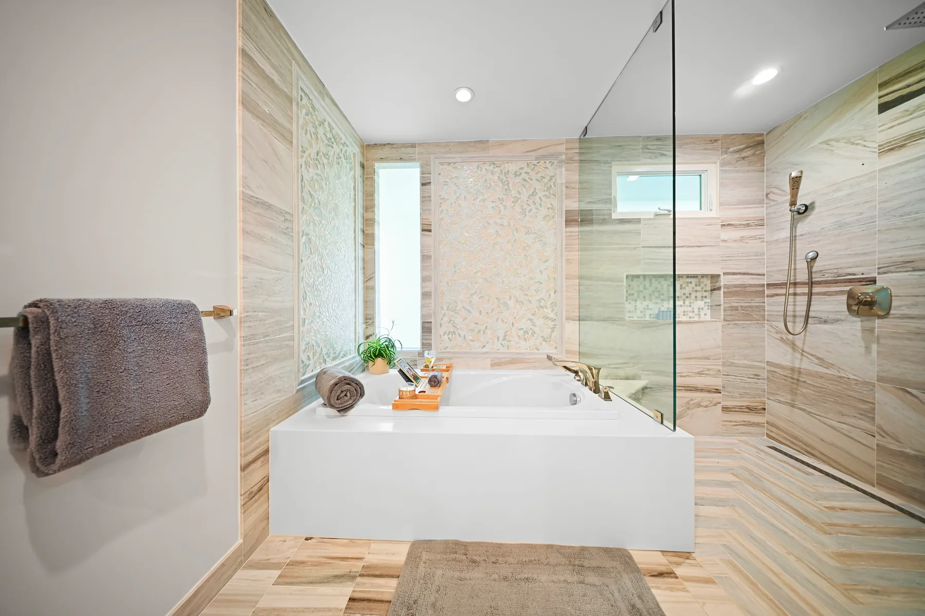 A bright bathroom with a bathtub and glass shower.
