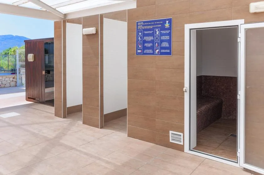 An outdoor shower area with tiled walls and an open shower stall.