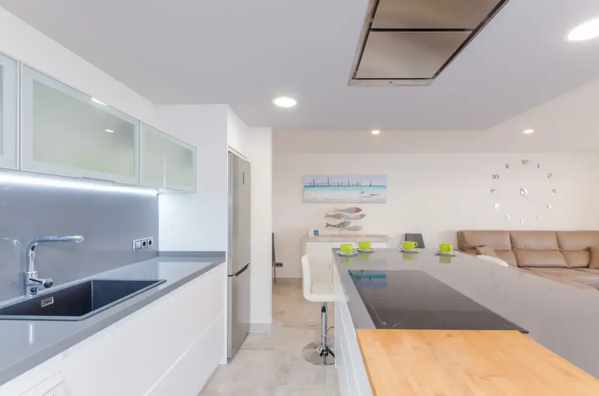 A bright open-plan kitchen and living area with a dining counter.