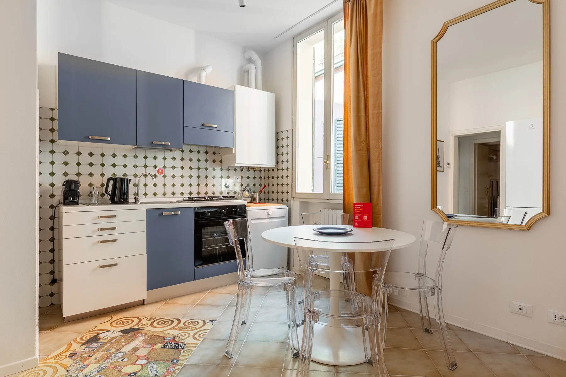A bright kitchen and dining area with blue cabinets and a round table.