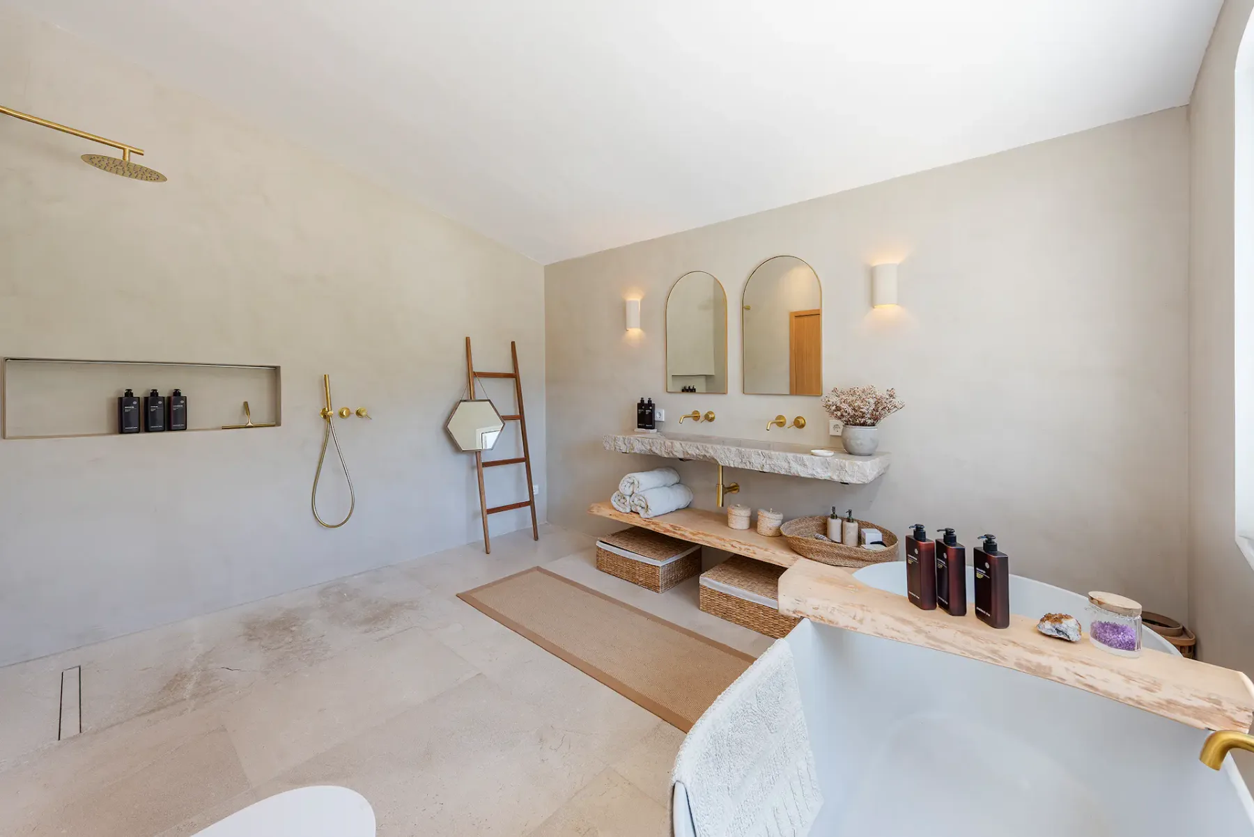 A bright bathroom features a long vanity with two mirrors and open shelving.