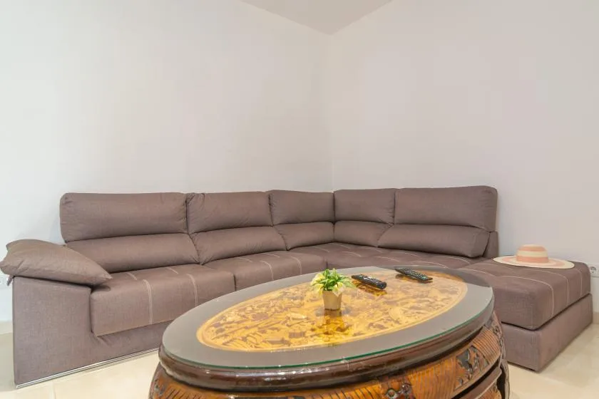 A living room with sectional seating and an oval coffee table.