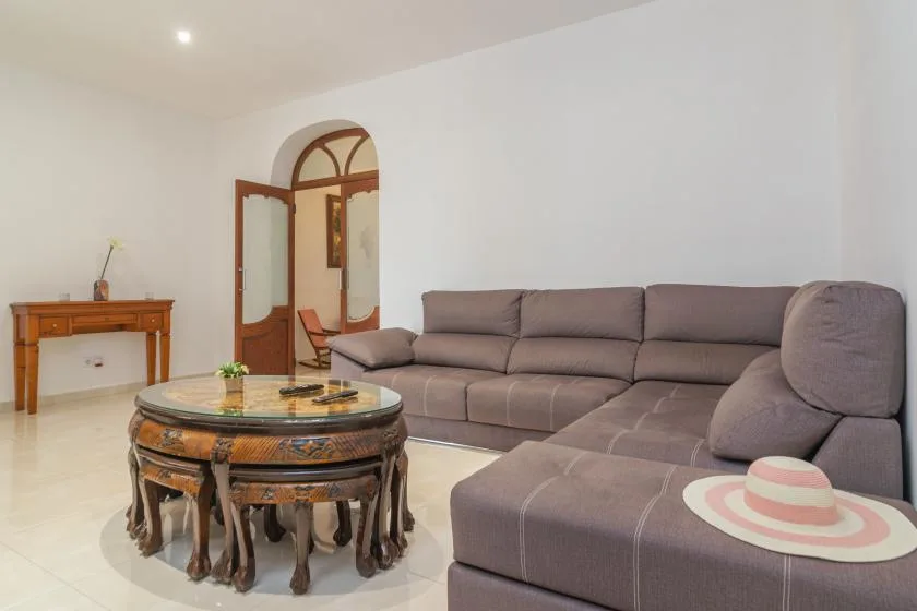Living room with a sectional seating area and an ornate round coffee table.