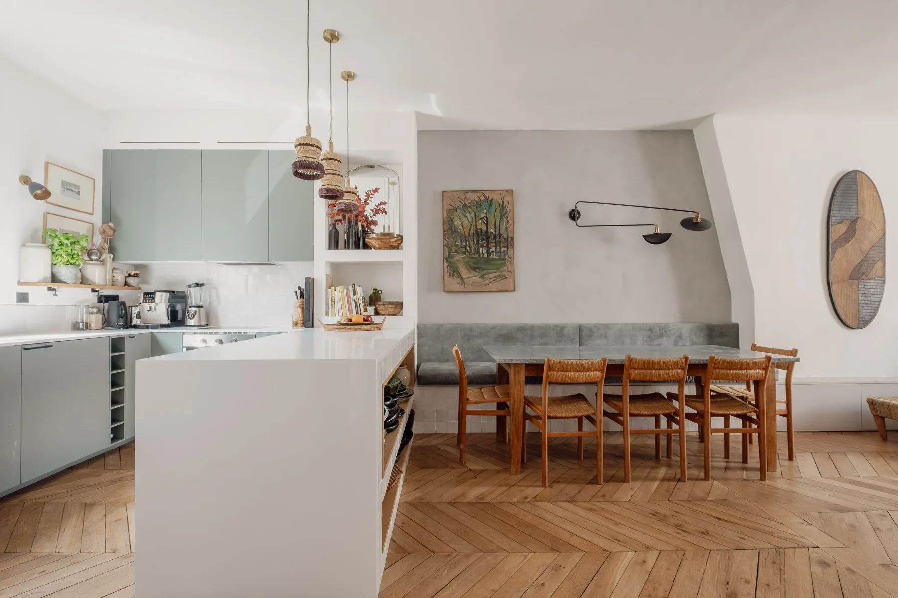 A modern kitchen and dining area with a long wooden table and chairs.