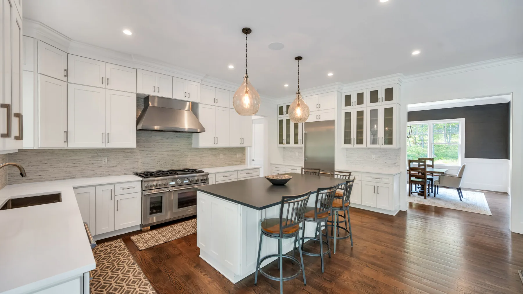 A bright kitchen with a central island and an adjoining dining area.