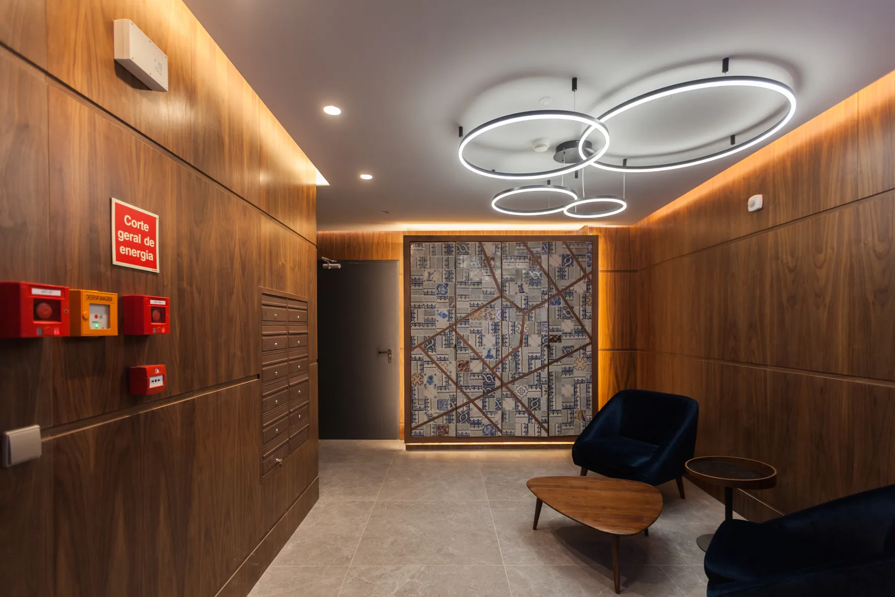 A wood-paneled lobby with a wall map and seating.