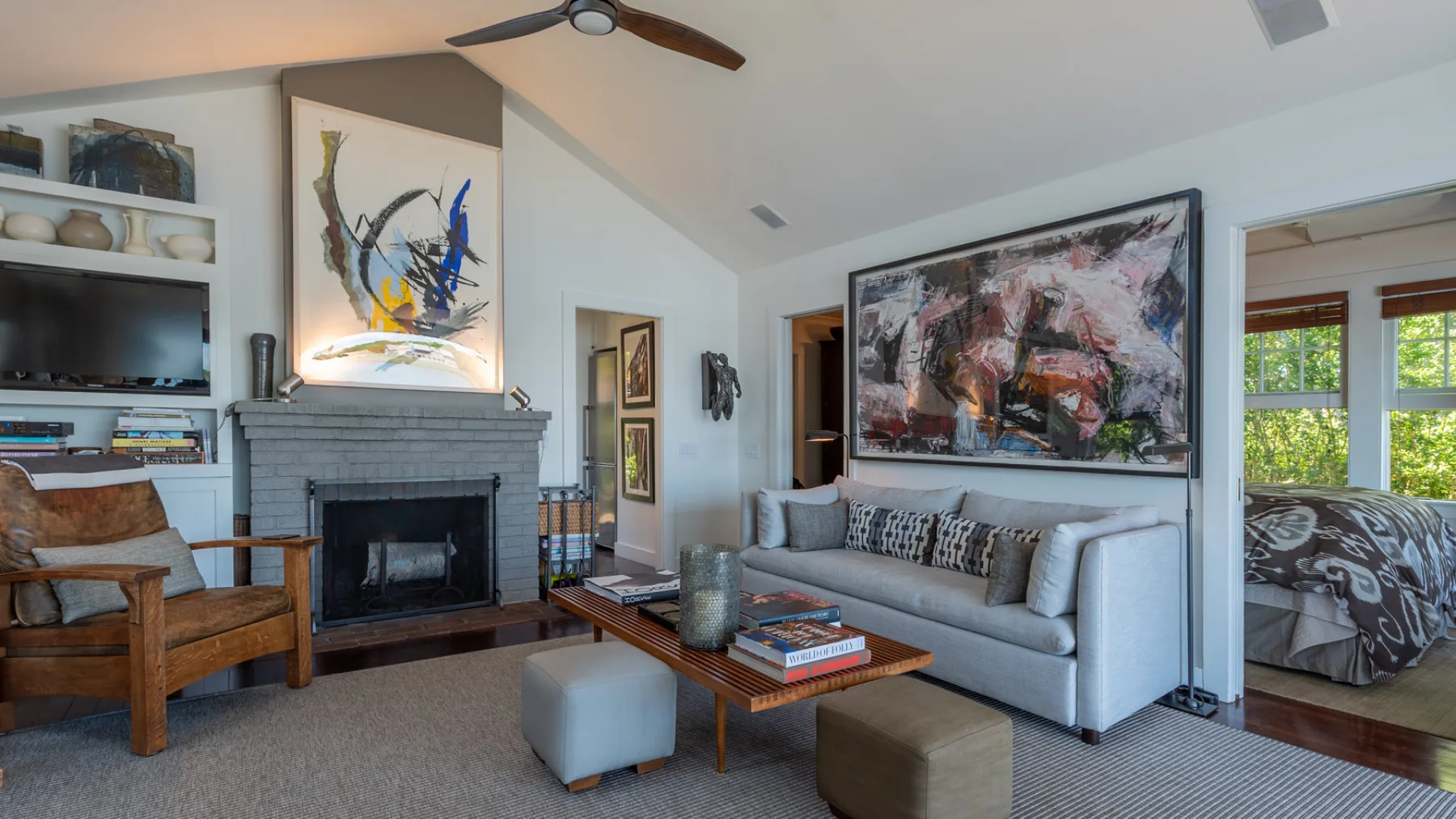 A living room with seating around a coffee table and a fireplace.