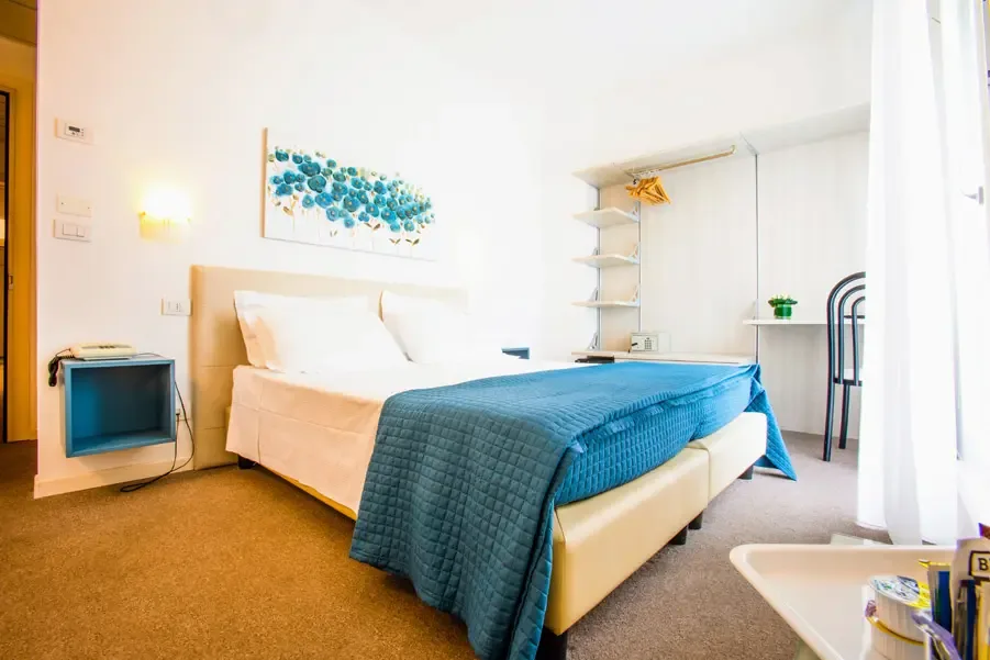 Bright Deluxe room with blue bedspread