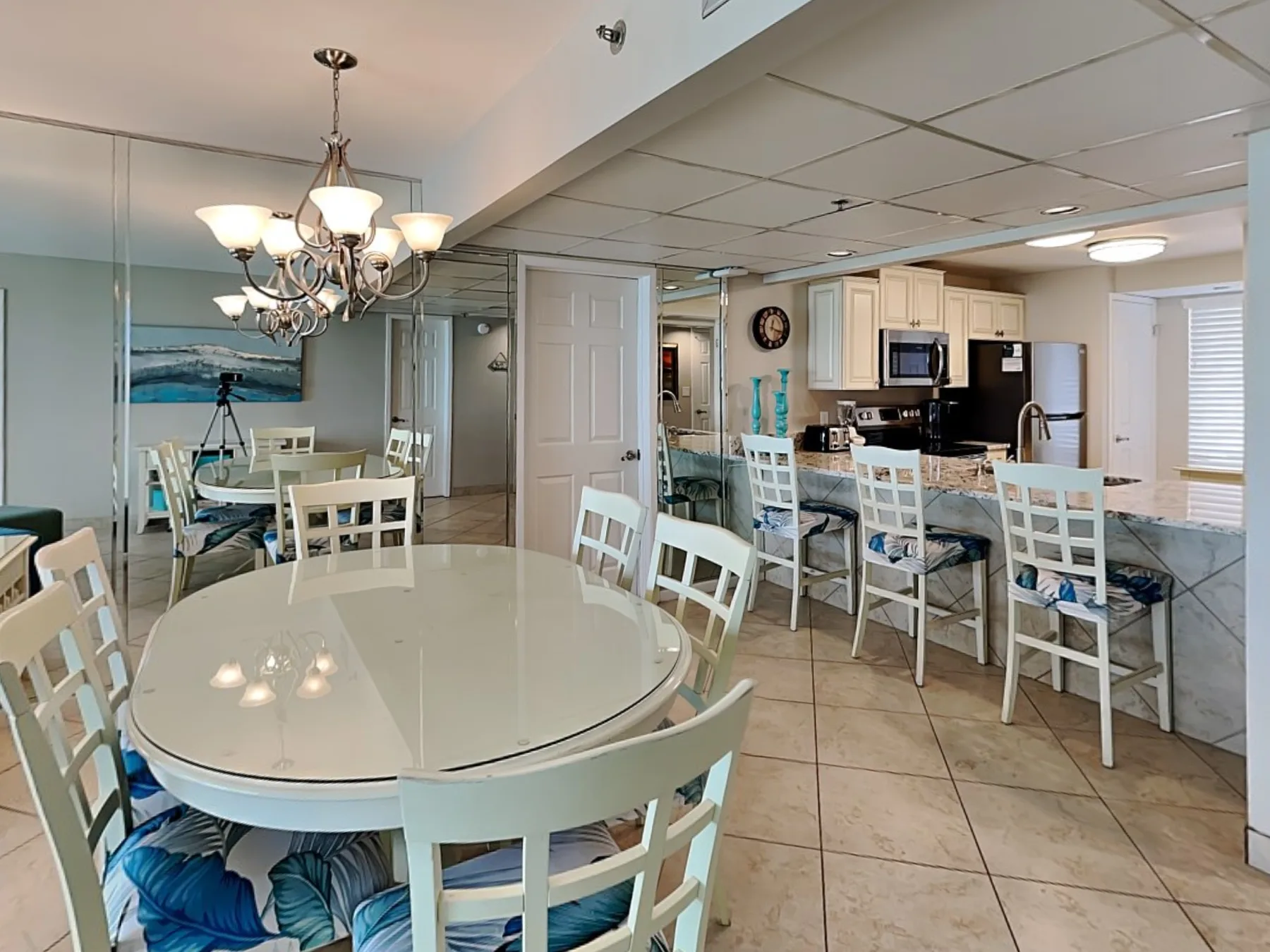 Dining area with a round table beside an open kitchen.