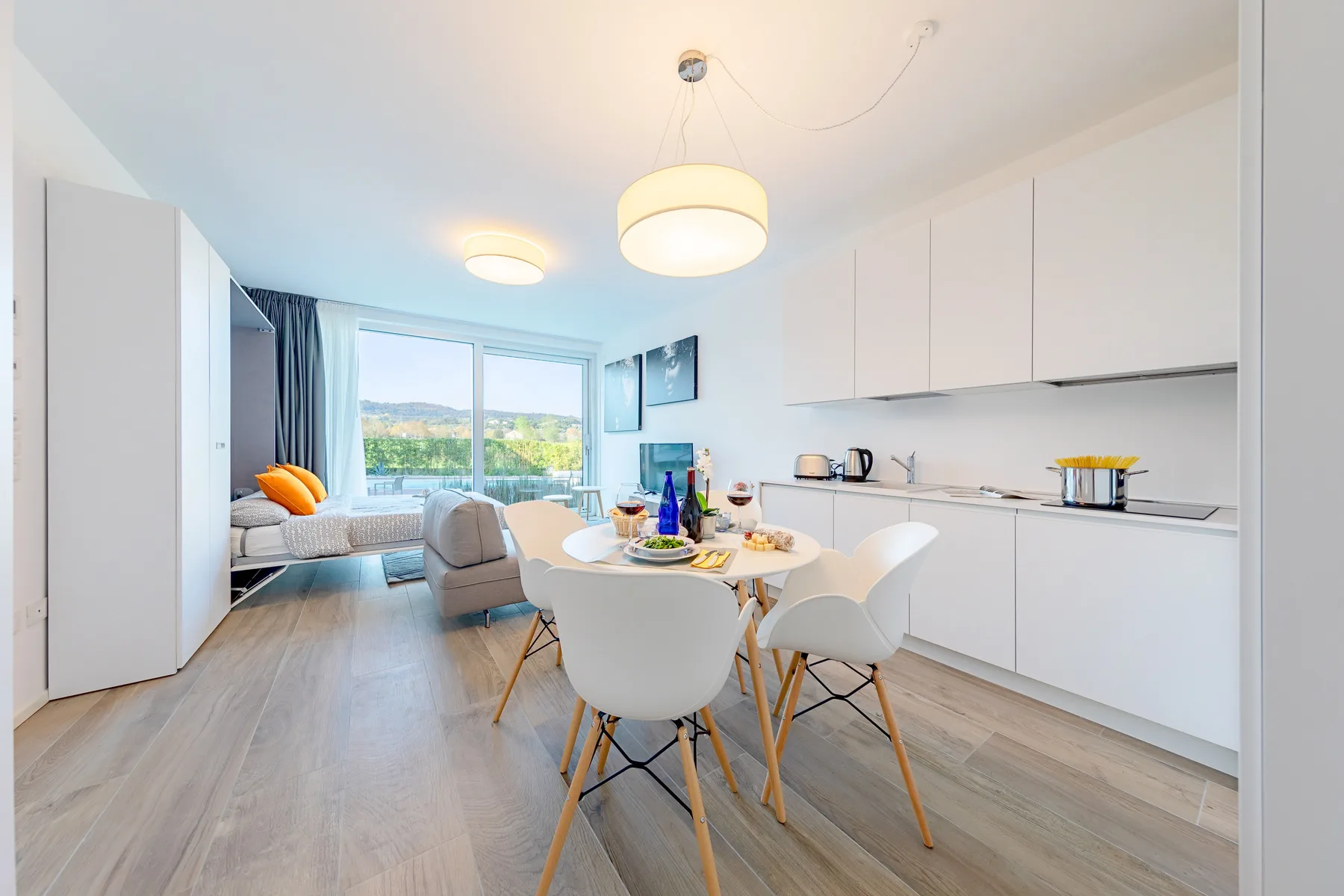 Un comedor luminoso con una mesa y sillas junto a una cocina moderna.
