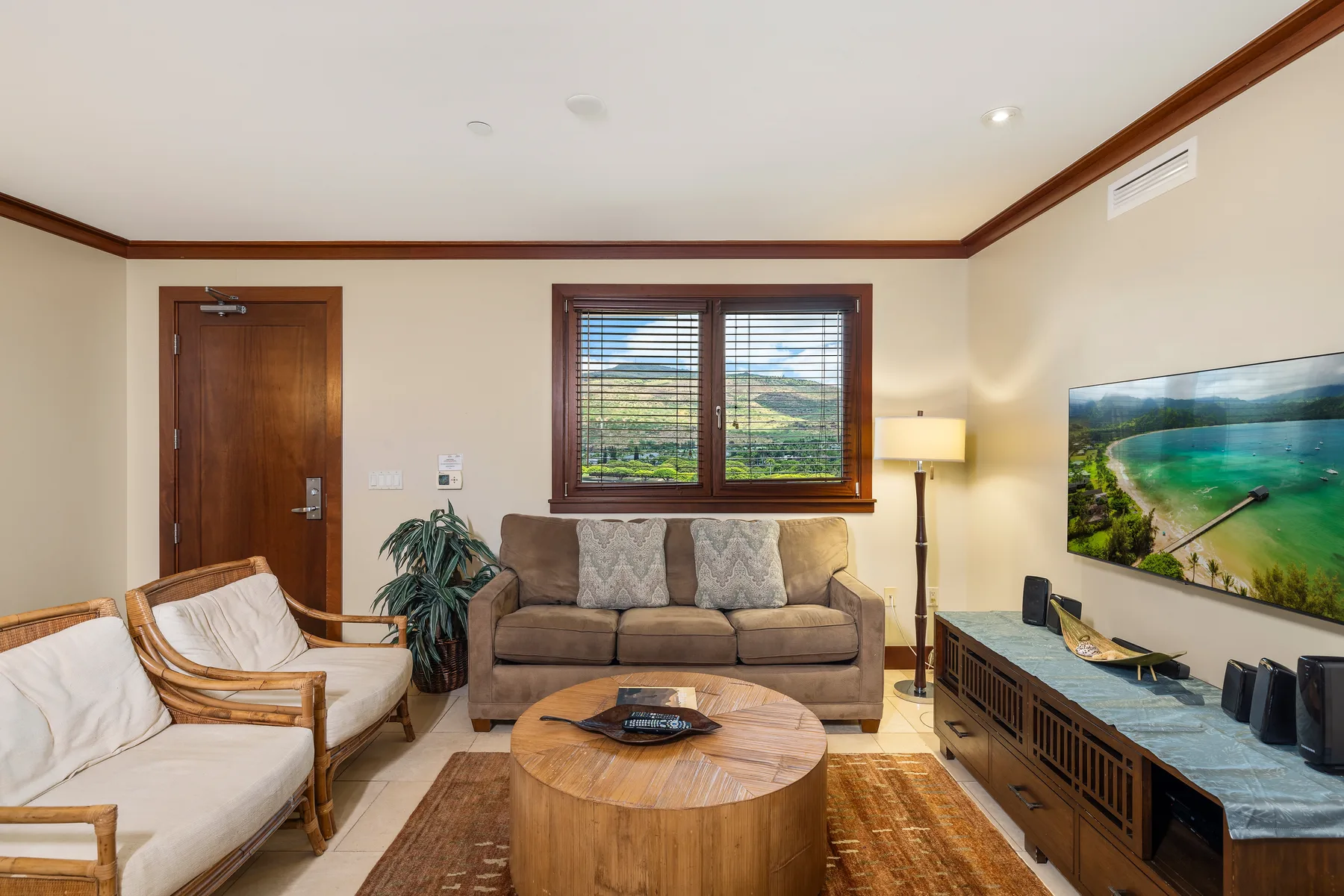 A living room with seating, a wooden coffee table, and a television.