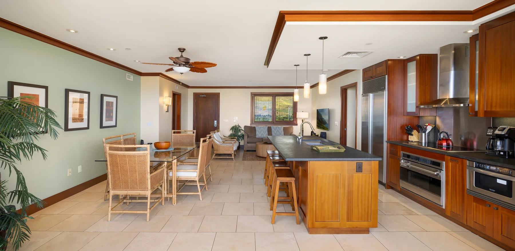 An open kitchen and dining area with wooden cabinetry and a central island.