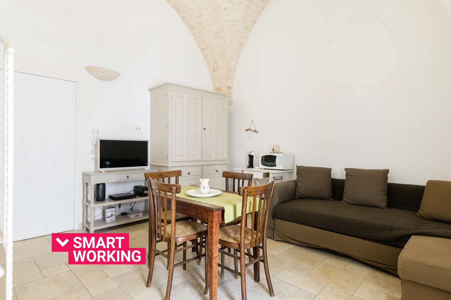 A living room with a dining table, television, and seating.