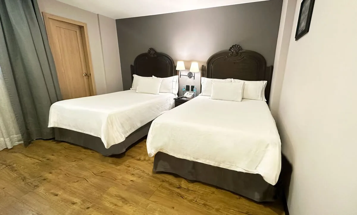 Standard room with two double beds, interior view