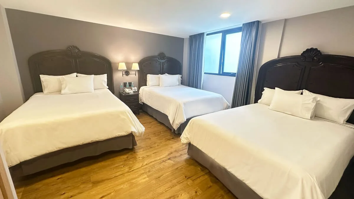 Standard room with three double beds, interior view