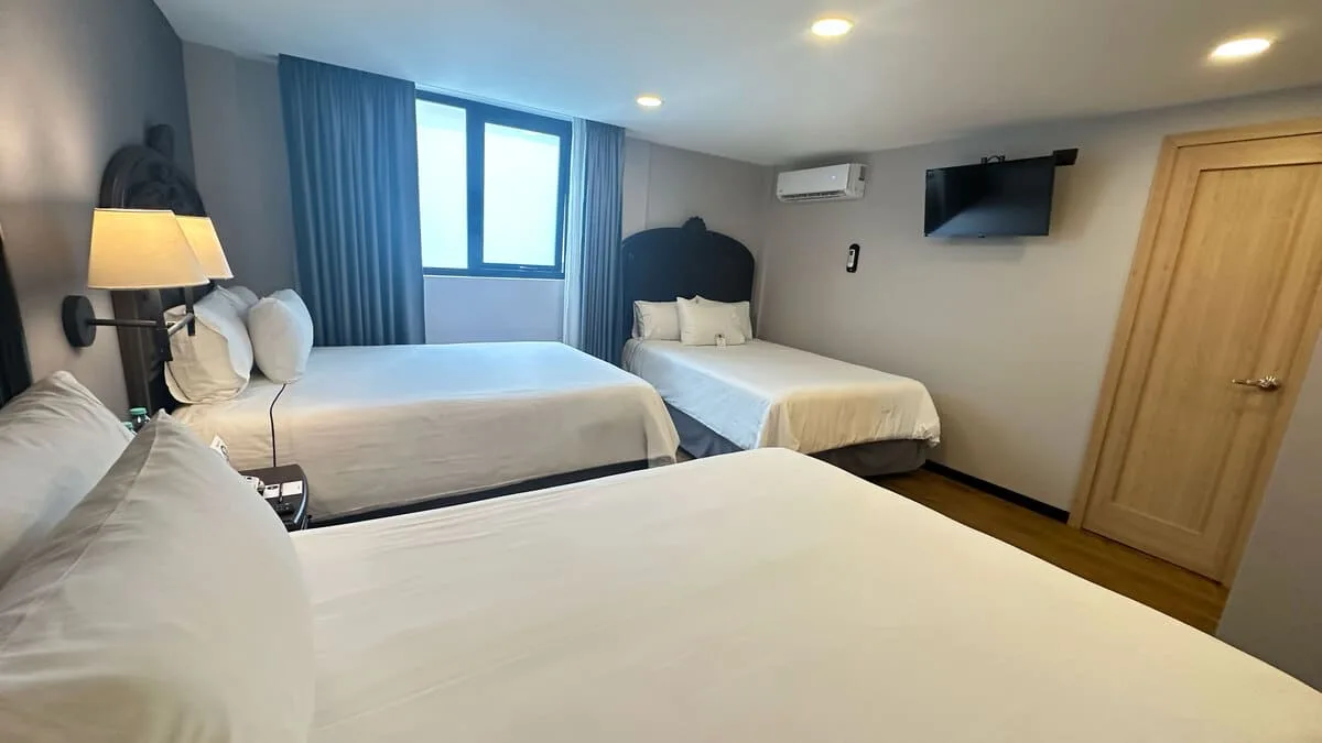 Standard room with three double beds, interior view