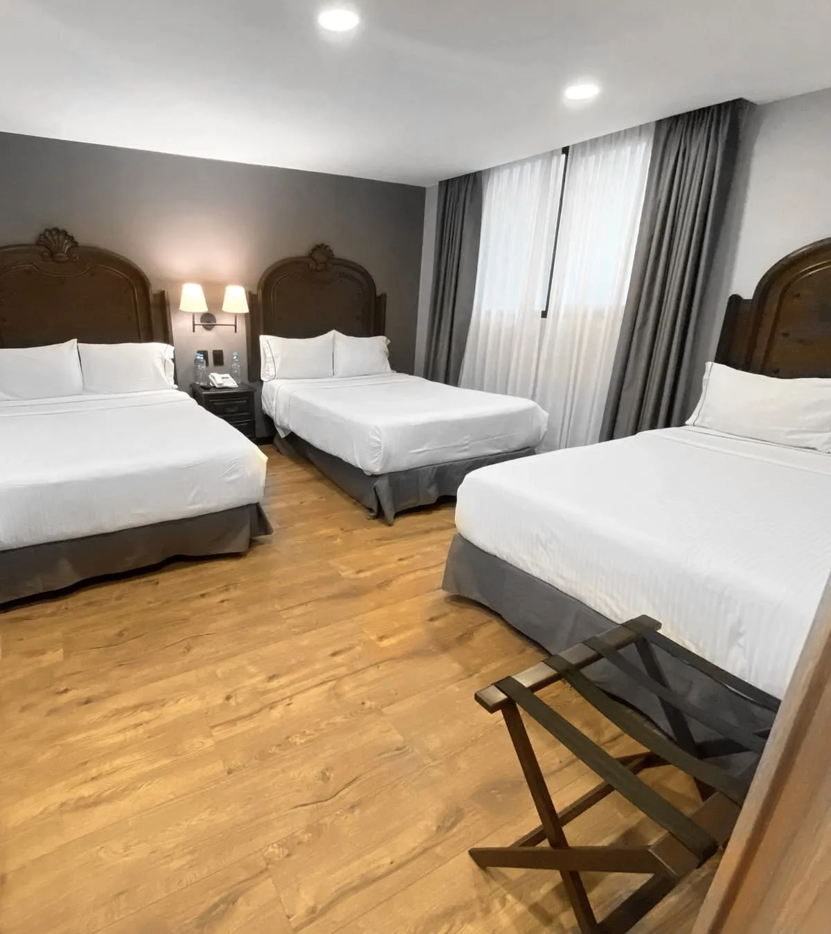 Standard room with three double beds, interior view
